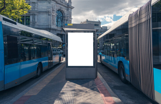 Urban bus stop with blank billboard in Madrid
