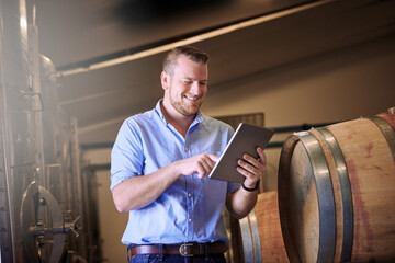 Business, man and smile with tablet in brewery as manager with pride on product, process or...