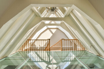 Modern geometric interior with glass floor and chandelier