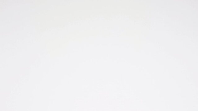 Paper sheets tearing from the center opening the screen transition. Stop motion animation. High quality 4k footage