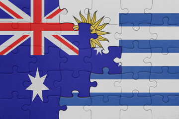 puzzle with the colourful national flag of uruguay and flag of australia.
