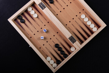 Board to play backgammon with pieces and dice. Board game, pastime, fun.