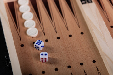 Board to play backgammon with pieces and dice. Board game, pastime, fun.
