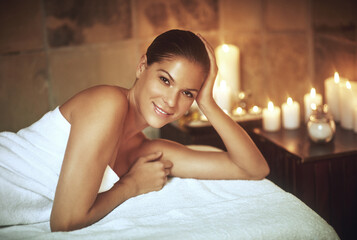 Woman, portrait and relax at spa with candles for luxury treatment, zen and wellness on massage...