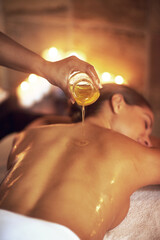 Body oil, back massage and masseuse with woman at spa for luxury, calm and relaxing pamper routine....