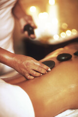 Massage, hot stones and back for woman, hands and detox for treatment at spa or salon. Rocks, mind...