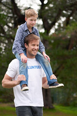 Playing, man and boy with piggyback in outdoor park for volunteering, fun game or support. Charity,...
