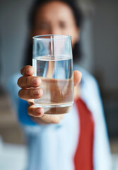 Hand, glass and person with water for wellness, wellbeing and hydration in home. Woman, drink and confident with self care for thirst, health and calm energy to detox for fresh, nature and pure