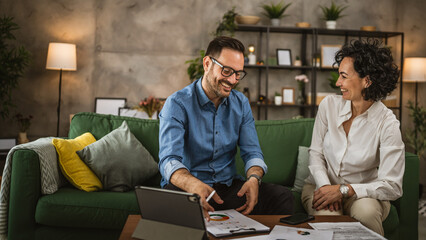 Two colleagues man and woman work on economy project together at home