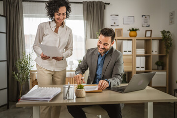 Adult man sign insurance or contract to his woman colleague at office