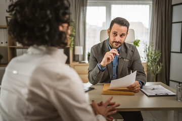 Mature woman sit at office and have job interview with manager or boss