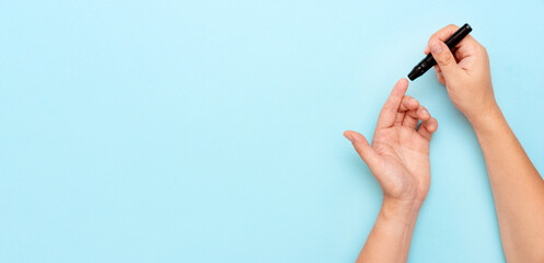 Close-up of man hands measuring glucose level