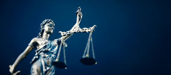 Lady Justice statue in law on blue background