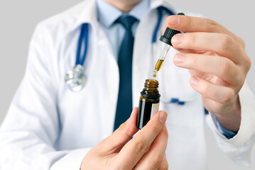 Doctor holding bottle of Cannabis oil