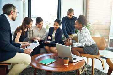 Collaboration, laptop and meeting with business people in lobby of office for discussion or...