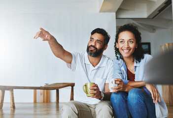 Couple, home and coffee for relax with point, calm and morning smile in living room. Love, house...