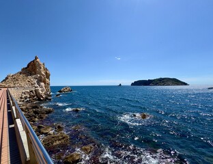 rocks at the Mediterranean Sea and a view towards the Illes Medes at the Cap de la Barra, Passeig...