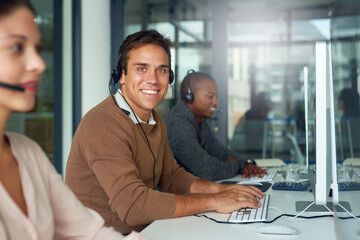Obraz premium Happy, man and portrait in call center for technical support and help in virtual customer care. Employee, consultant and contact us for advice, feedback and crm communication with solution to faq