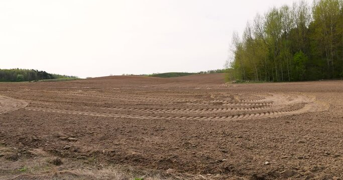 tread marks of heavy machinery on a plowed field, plowed soil of a field with traces of cars