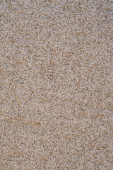 close-up of decorative plaster on the facade of a beige house vertically