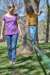 Little boy trying to walk on slackline