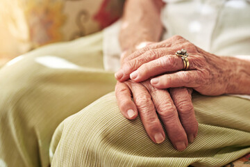 Closeup, sofa and hands of elderly woman in retirement home for thinking, reflection and nostalgia...