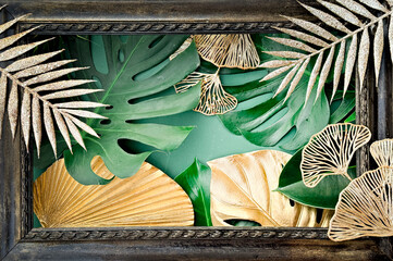 Ornate dark frame featuring a vibrant, tropical arrangement of green monstera leaves and elegant...