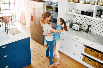 Home, kitchen and mom hug girl or dance with love, care and support in family on weekend. Happy,...