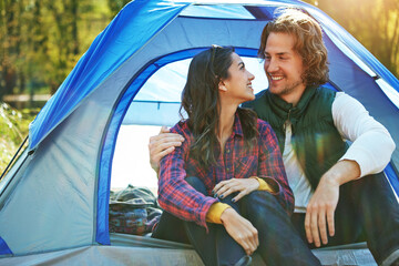 Couple, hug and relax in tent or camping with love and happiness together on adventure in woods....