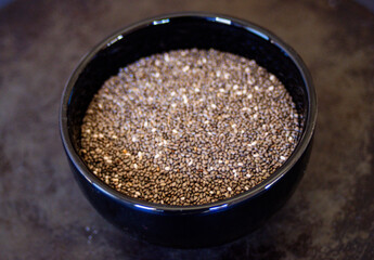 Very close up photo of back bowl with chia seeds. Still life. 