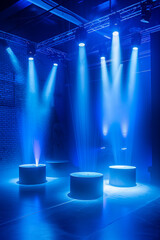 A blue lit room with three lighted pedestals. Film studios