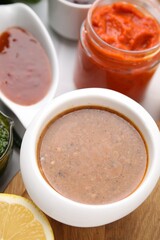 Different marinades in tableware on table, closeup