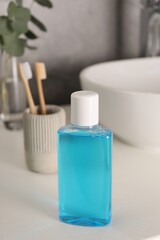 Bottle of mouthwash on white countertop in bathroom