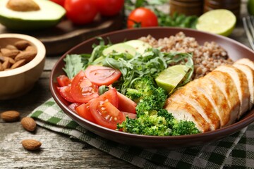 Healthy meal. Tasty products in bowl on wooden table, closeup