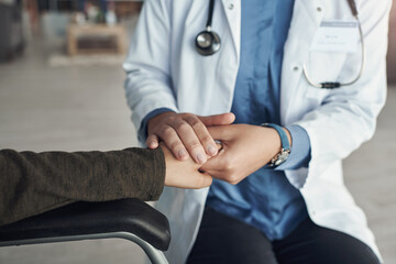 Doctor, person and holding hands for healthcare support in hospital office with closeup, empathy...