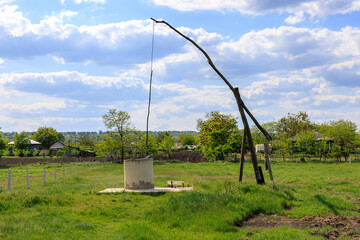 A large wooden pole is attached to a water pump