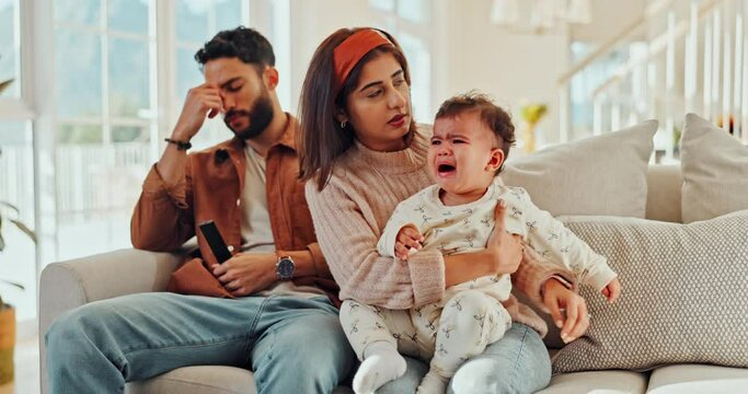 Crying, home and parents with baby for comfort, empathy and care for emotional child on sofa. People, family and mom, dad and newborn on couch with stress, frustrated and burnout for parenting