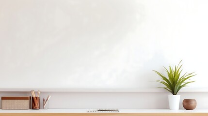 Workspace - office table, empty desk with supplies against the white wall