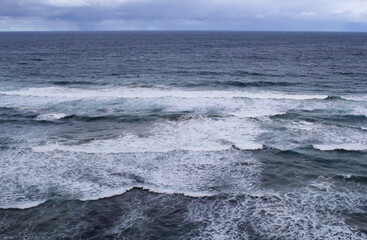 Ocean view with waves and a cloudy sky