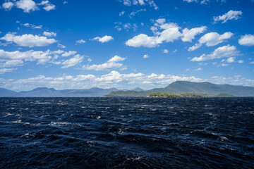 Yacht sailing on the horizon near the beach on the ocean ina  remote beautiful landscape, Tasmania, Australia and new zealand
