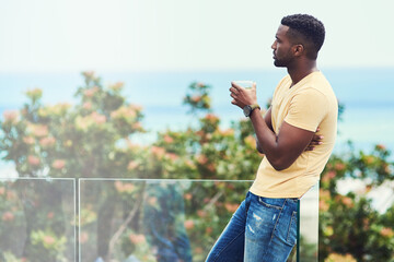 Black man, balcony and drink to relax in outdoor, thinking and alcohol or juice on morning. Male...
