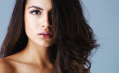 Hair care, portrait and woman with natural beauty in studio for shine, keratin treatment or glow on...