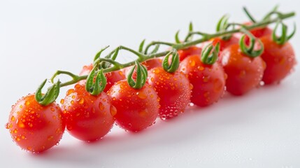 Fresh cherry tomatoes on the vine, glistening with water droplets, arranged against a clean white background.
