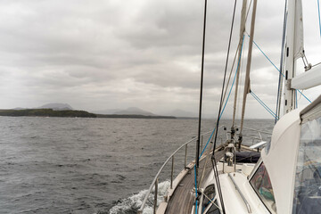 sailing on a yacht in the australian in the remote forest wilderness in spring in australia with waves breaking