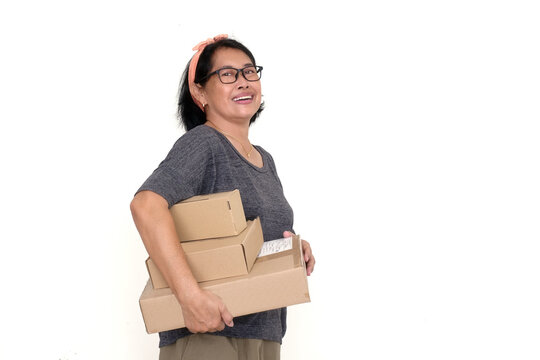 Asian adult woman carrying some carton boxes with one hand