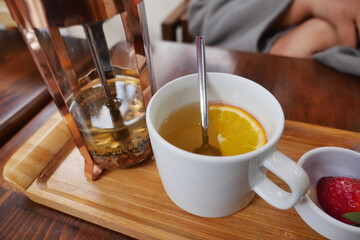 a cup of lemon tea on a table 