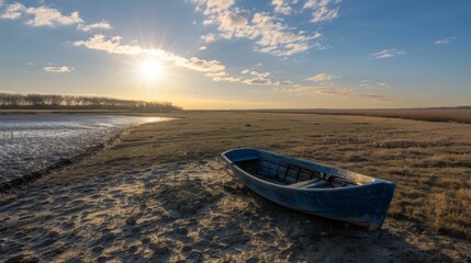 A serene landscape with a lone blue rowboat beached on the sandy shore, under a golden sunset sky.