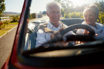 Old couple, driving and convertible car or travel road trip to explore California, retirement or...