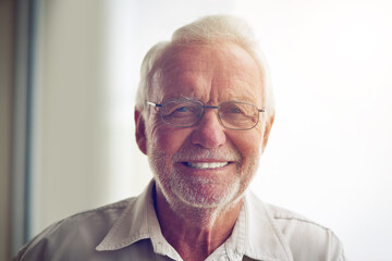 Portrait, home and old man with glasses, smile and happiness with confidence, peace or retirement....