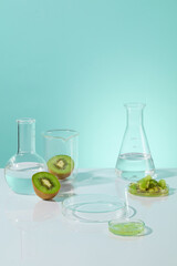 Vertical photo on baby blue texture with vacant space for showing product and fresh kiwi decorated. Template for organic product advertising, which extract from natural ingredient, copy space